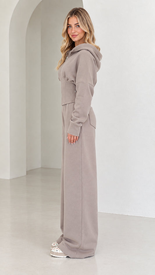 Side profile view of taupe corset tracksuit set showcasing tailored silhouette