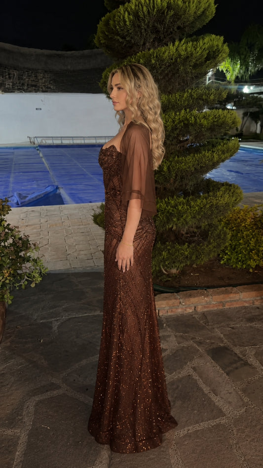 Side profile of woman in brown beaded floor-length formal gown