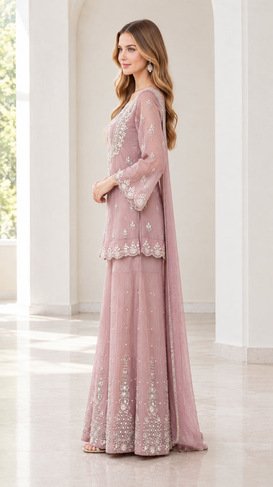 Side profile view of women wearing dusty rose 3-piece embellished sharara suit set