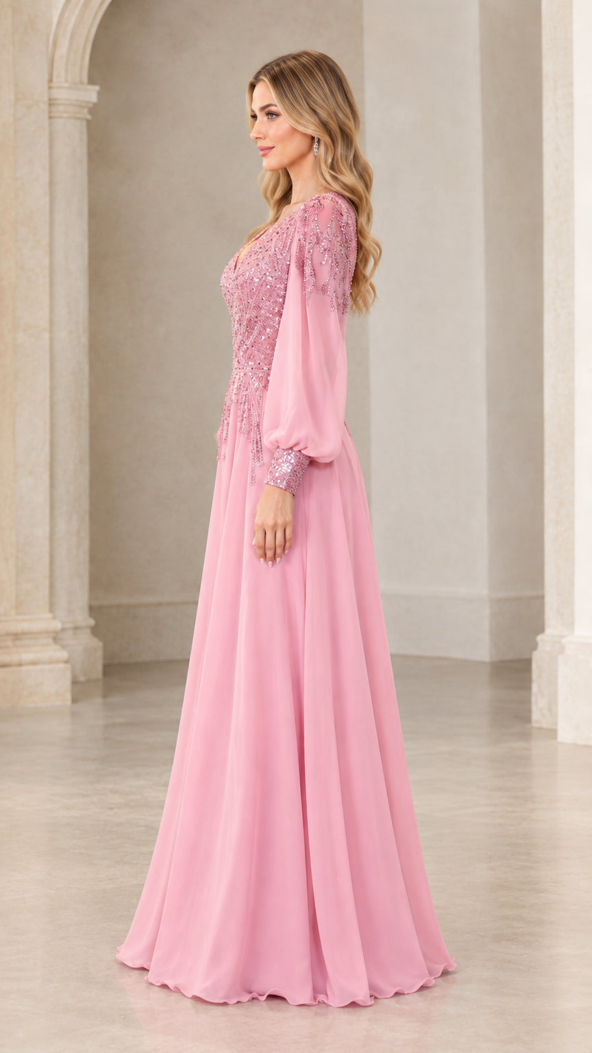 Side profile view of model wearing pink long sleeve formal evening gown