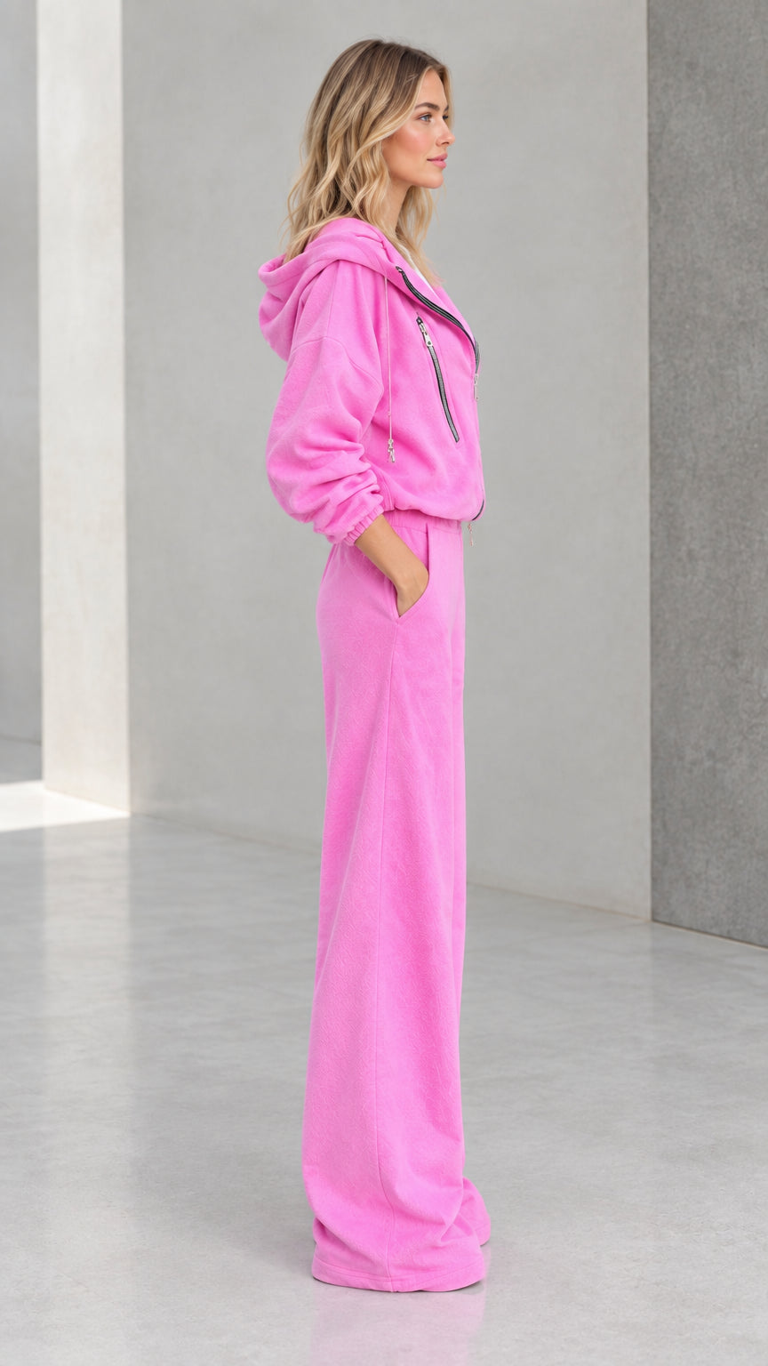 Side view of model wearing pink two piece hooded tracksuit set