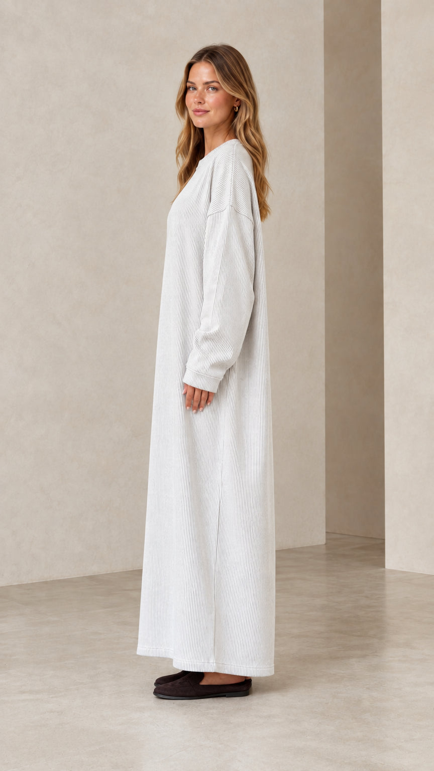 Side profile view of light grey ribbed knit long sleeve maxi dress