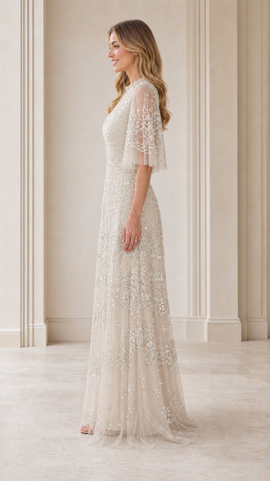 Side profile view of model in champagne floor-length gown