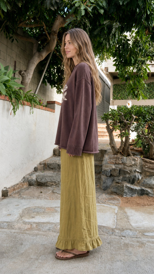 Side profile of model in Brown graphic fish knit pullover