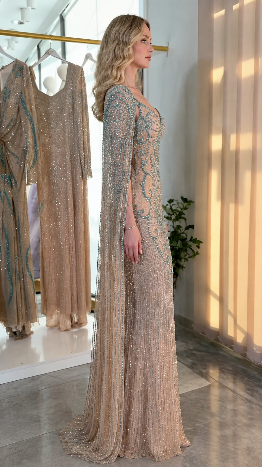 Side profile view of champagne embellished formal gown showing cape drape