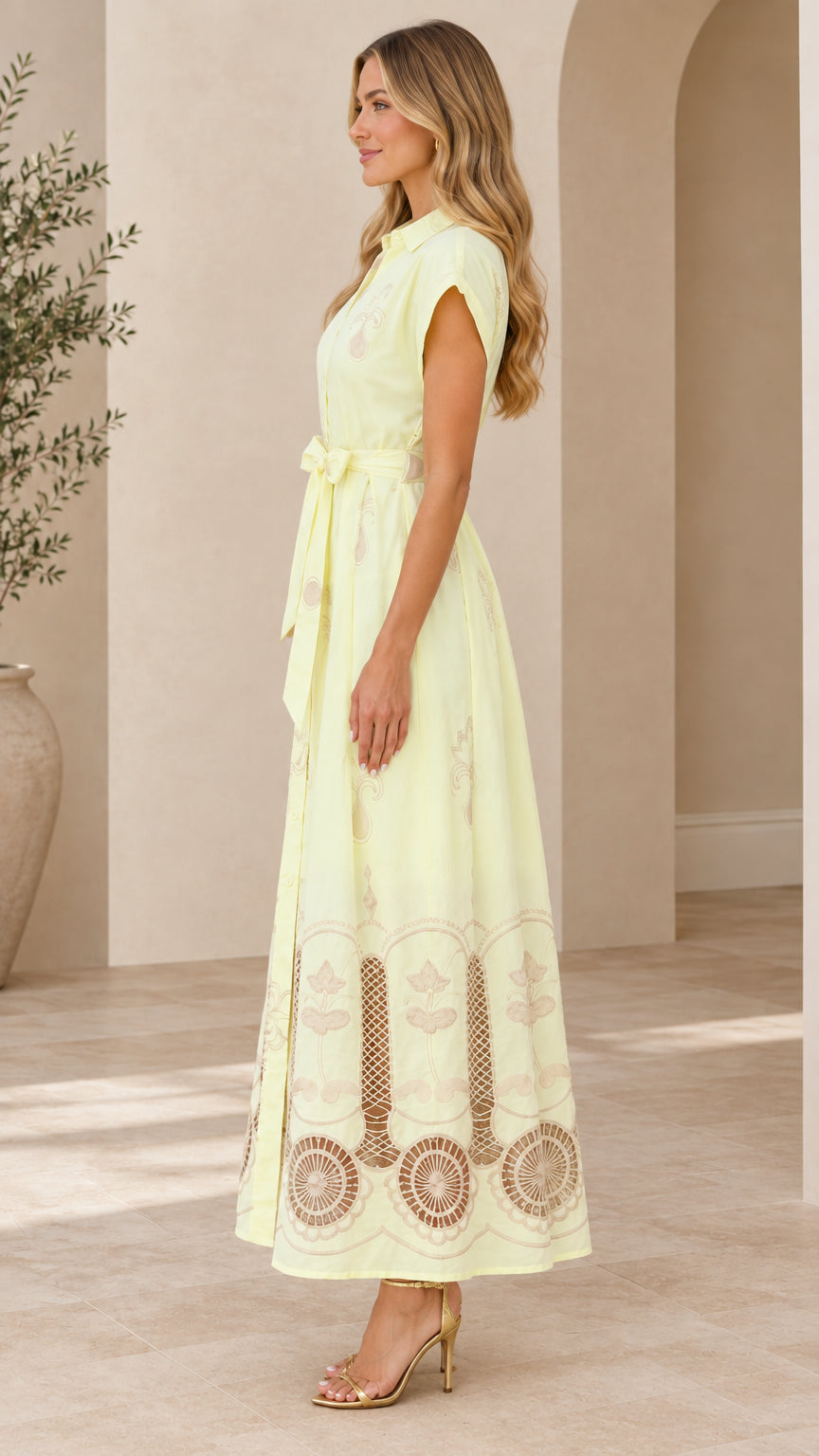 Side profile view of pale yellow embroidered maxi dress showing cap sleeves and hem details