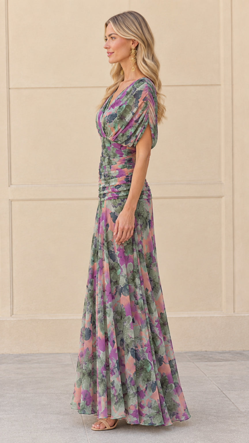 Side profile view of woman modeling sage purple draped sleeve floral maxi dress