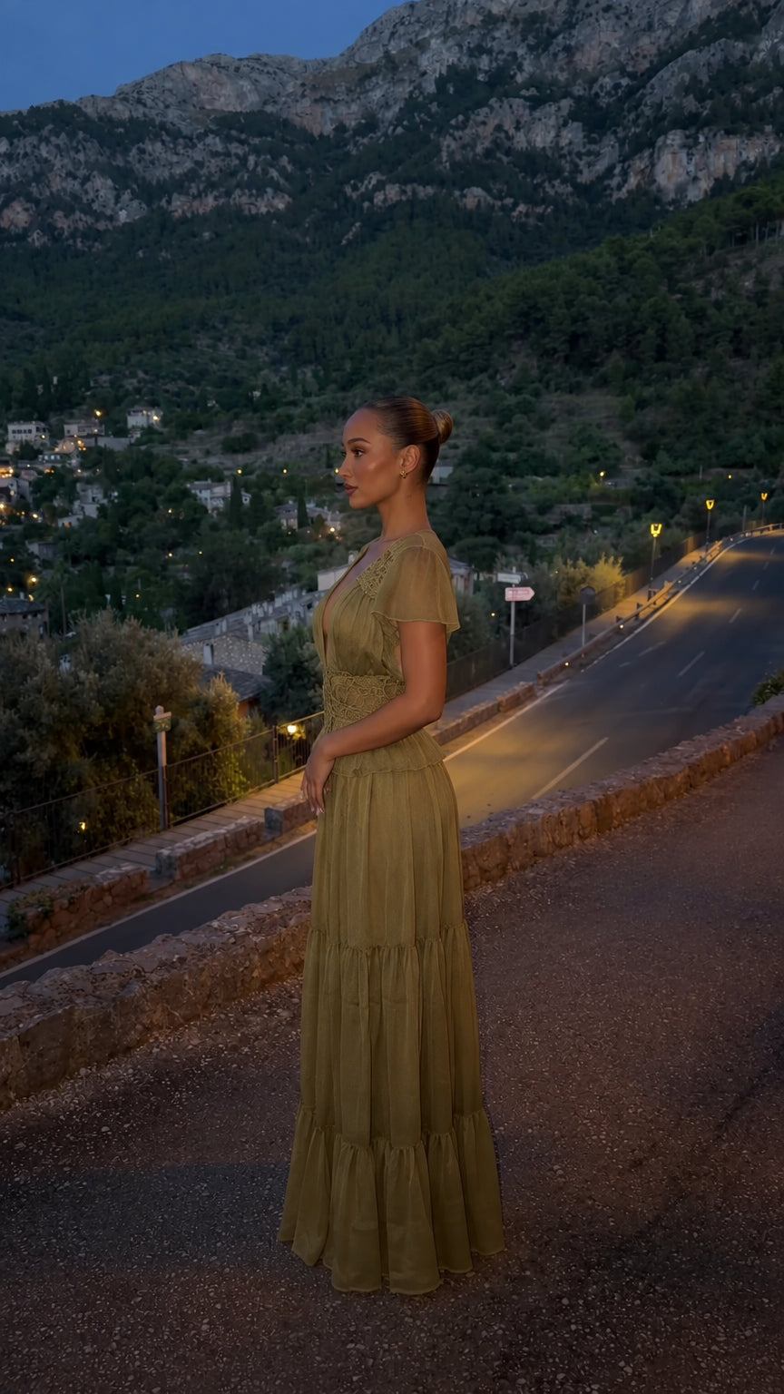 Side view of model in olive green flutter sleeve tiered maxi dress