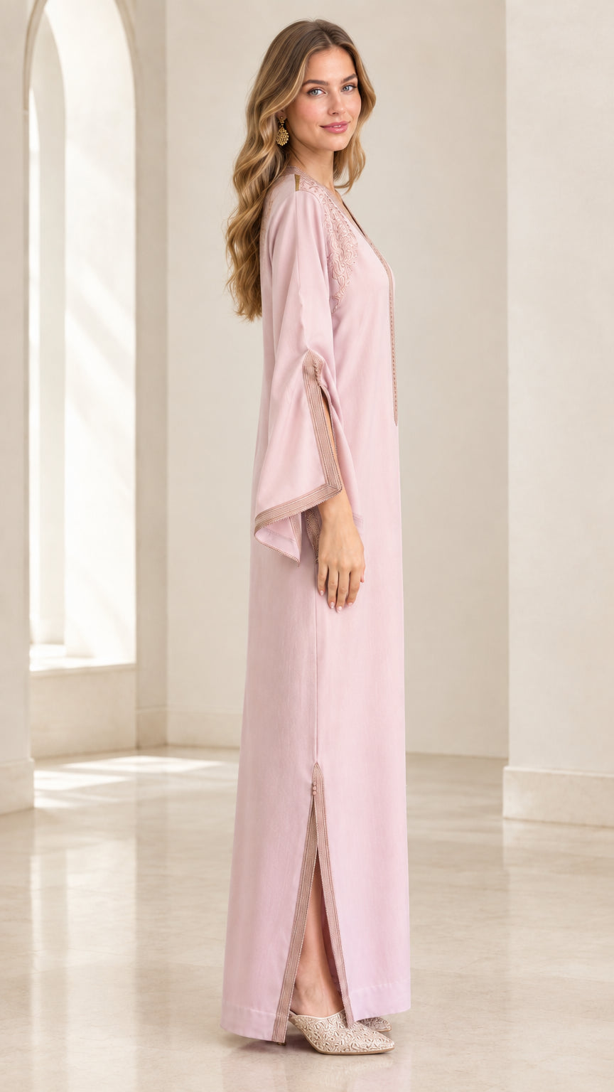 Side profile of woman wearing Dusty Pink kaftan dress highlighting sleeve slits and straight silhouette