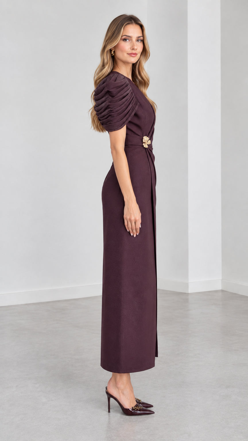 Side profile view of woman modeling Plum pleated sleeve tailored evening maxi dress