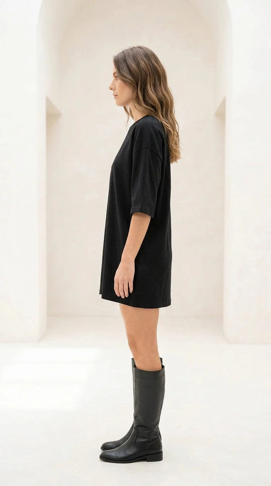 Side profile view of black oversized t-shirt dress