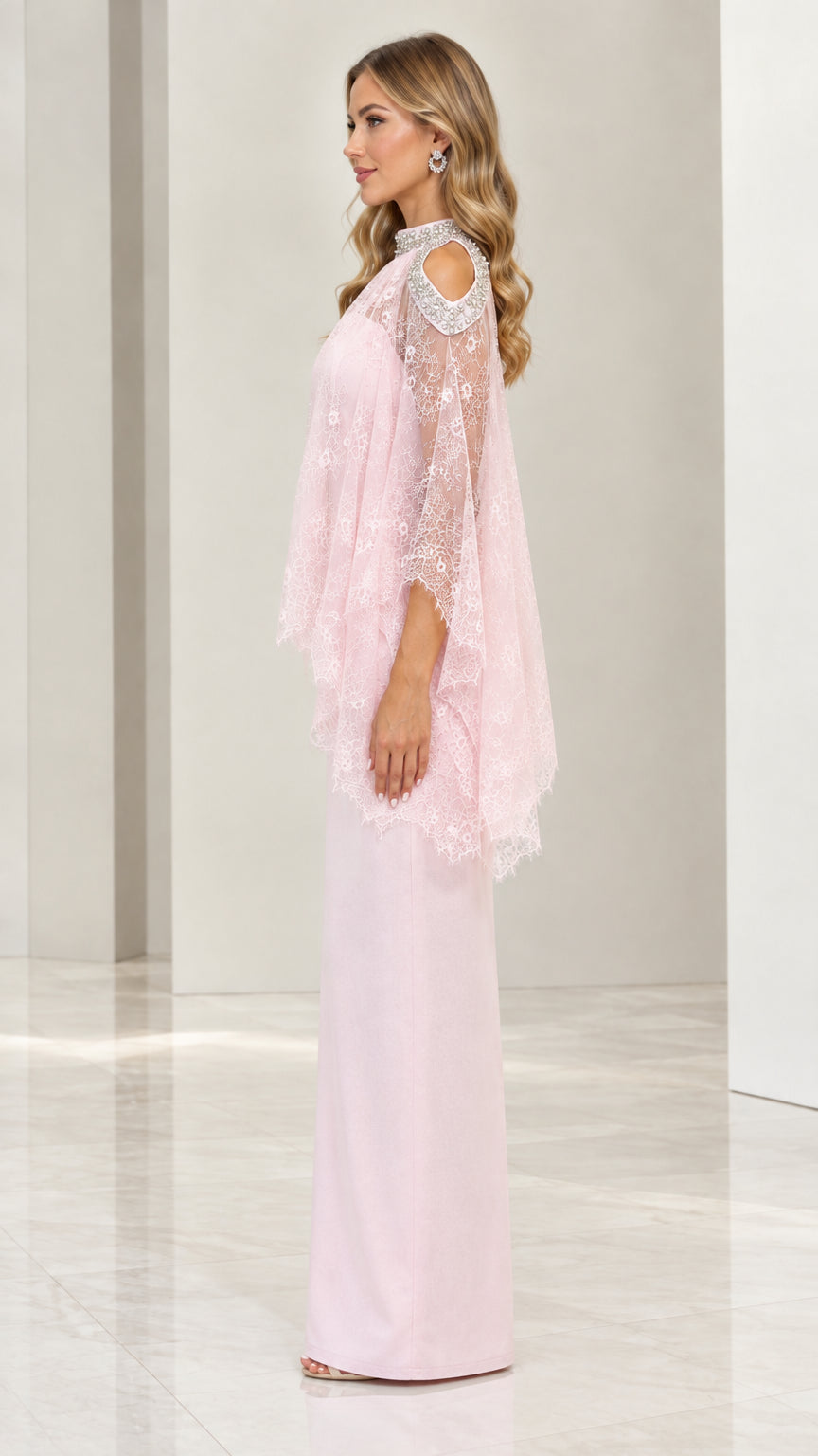 Side profile view of blush pink formal dress with sheer lace poncho overlay