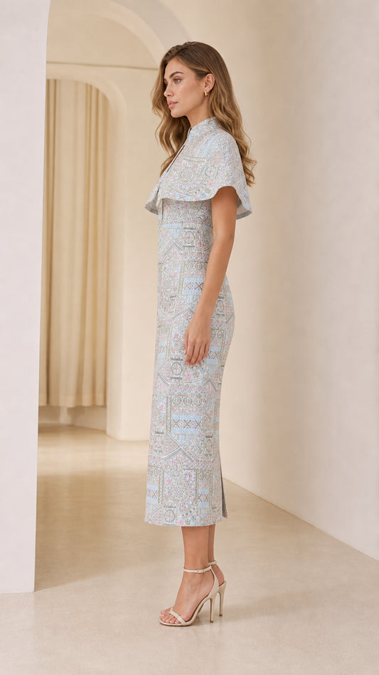 Side profile of model in Light Blue capelet sheath midi dress