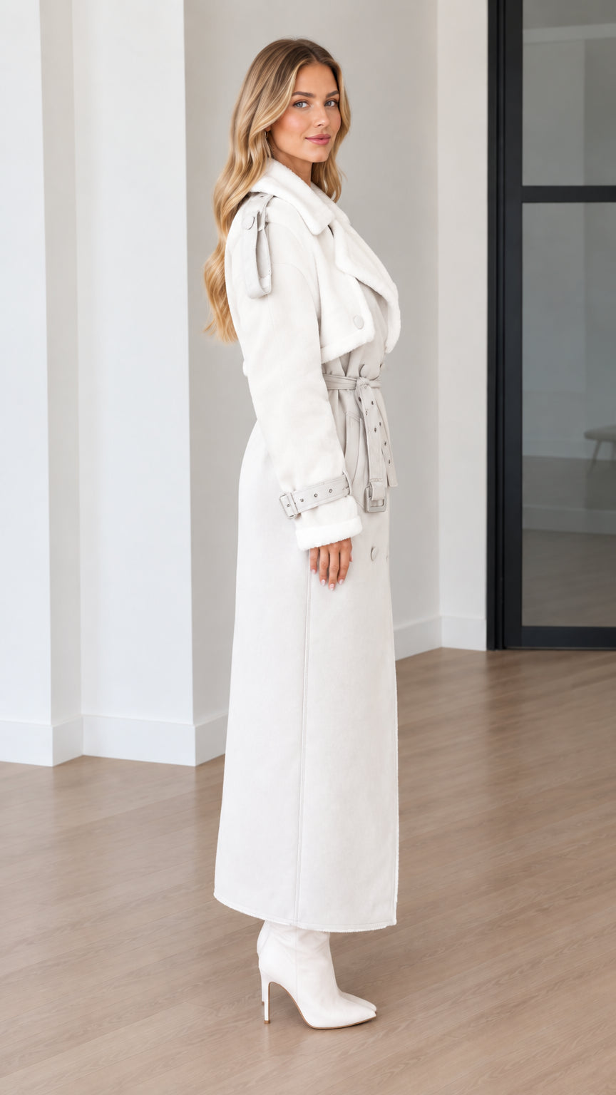 Side profile of model in an off-white faux shearling lined maxi coat