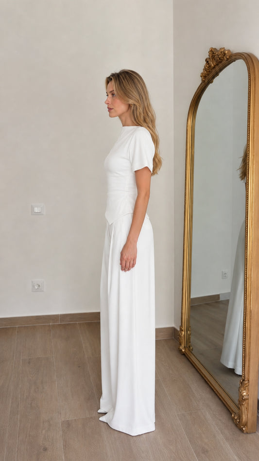 Side profile view of woman in white matching pant set