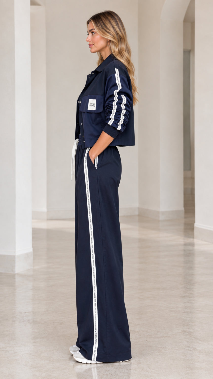 Side profile view of Navy Blue cropped jacket and wide-leg athletic pants set