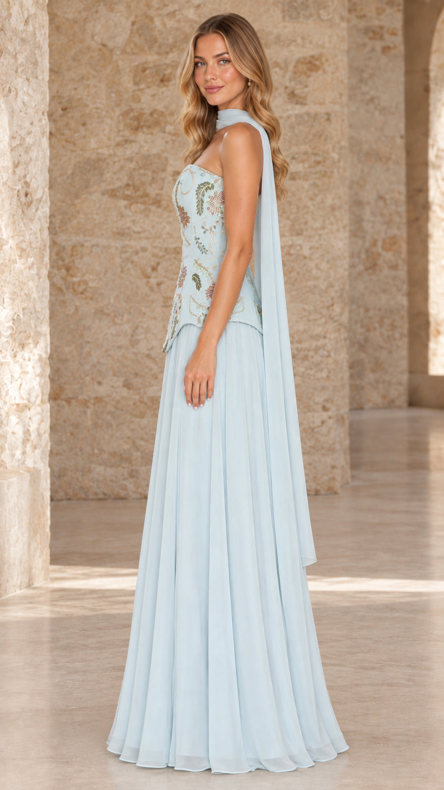 Side profile of sky blue formal gown showing trailing chiffon scarf and flowy skirt
