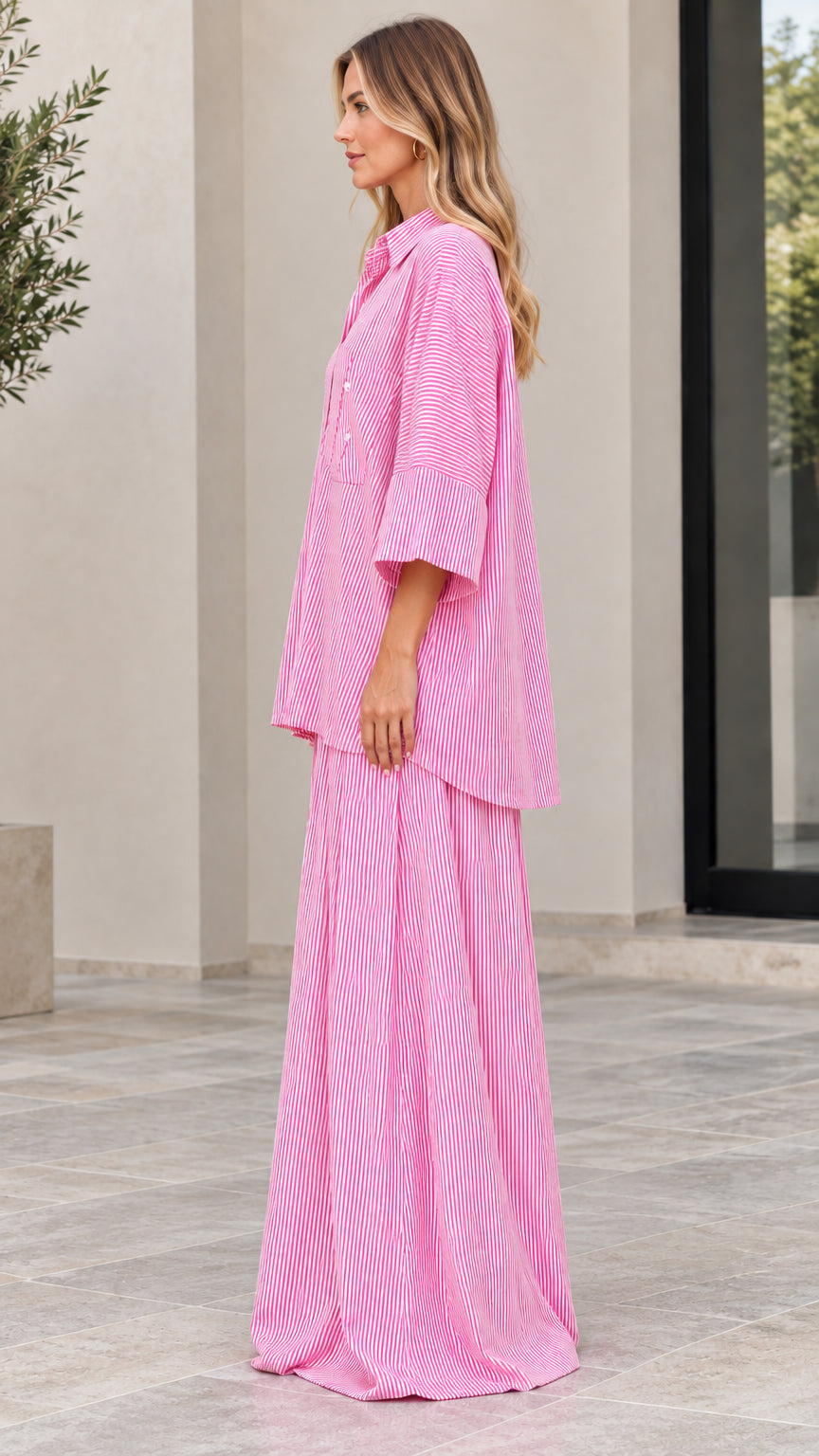 Side view of woman wearing pink vertical striped matching two-piece set