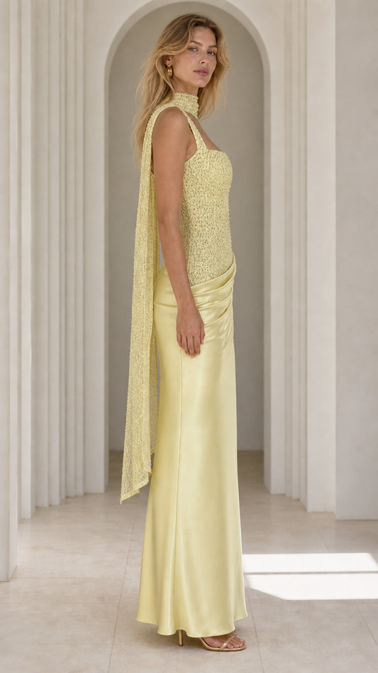 Side profile view of yellow evening gown with scarf