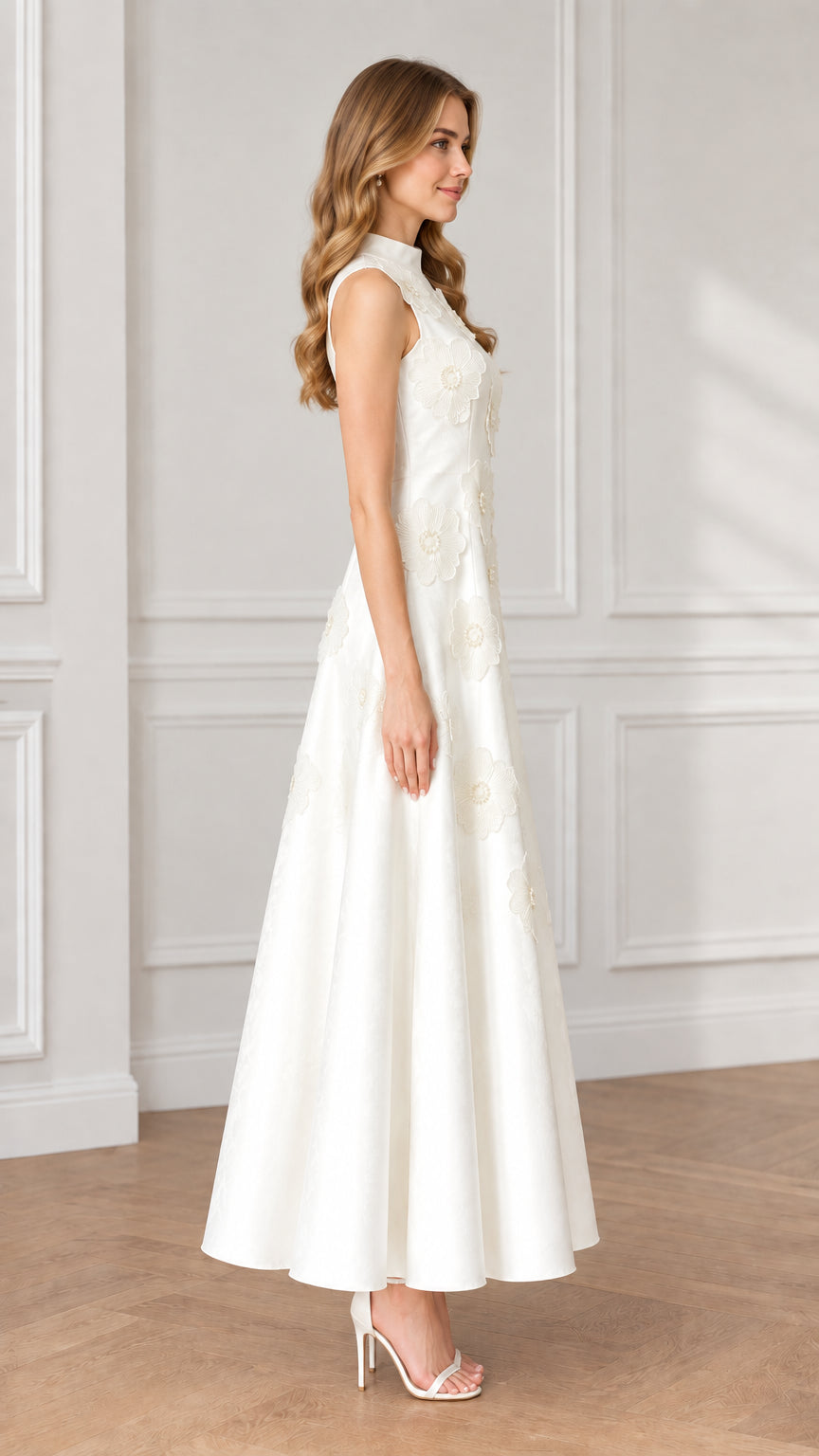 Side profile view of white sleeveless floral appliqué maxi dress