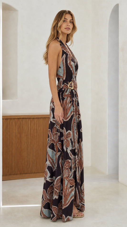 Side profile view of black abstract print halter maxi dress