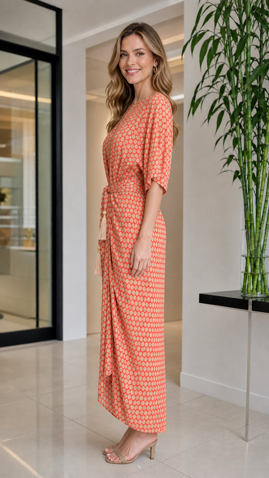 Side profile view of orange geometric print maxi dress