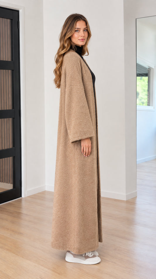 Side view of model in camel textured knit maxi duster cardigan