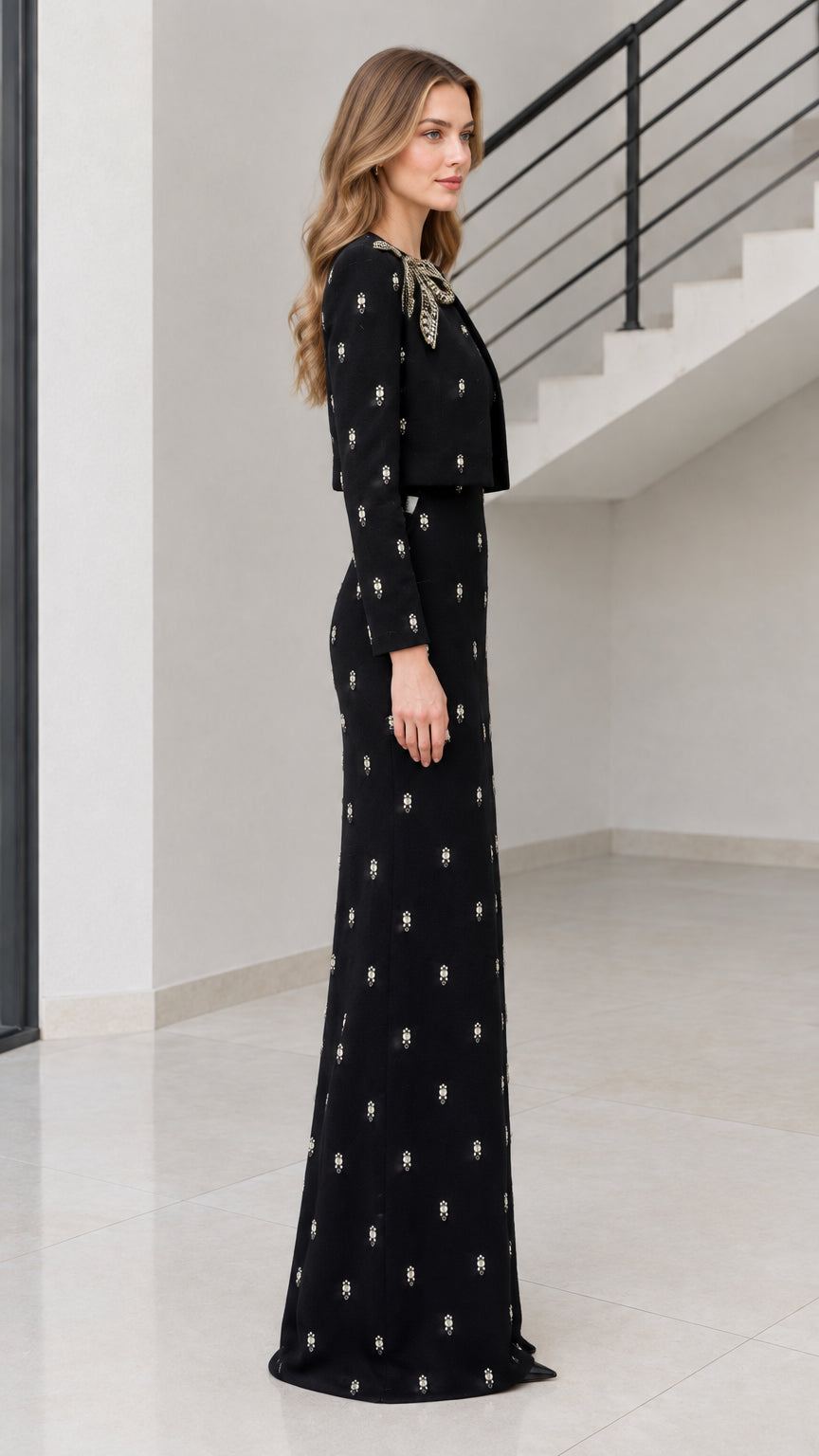 Side profile of woman wearing black embellished two-piece evening gown set