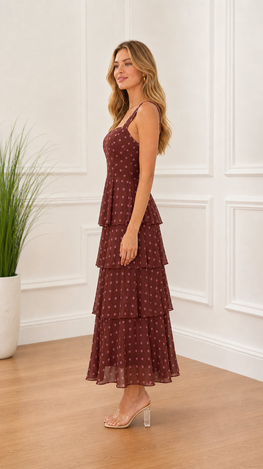 Side profile of model in burgundy polka dot midi dress