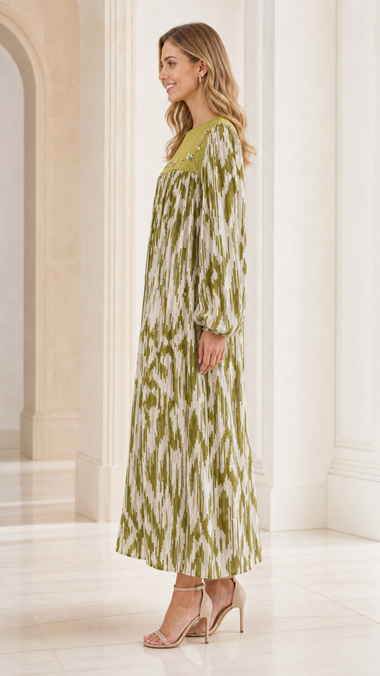 Side profile of woman wearing olive green long sleeve pleated maxi dress