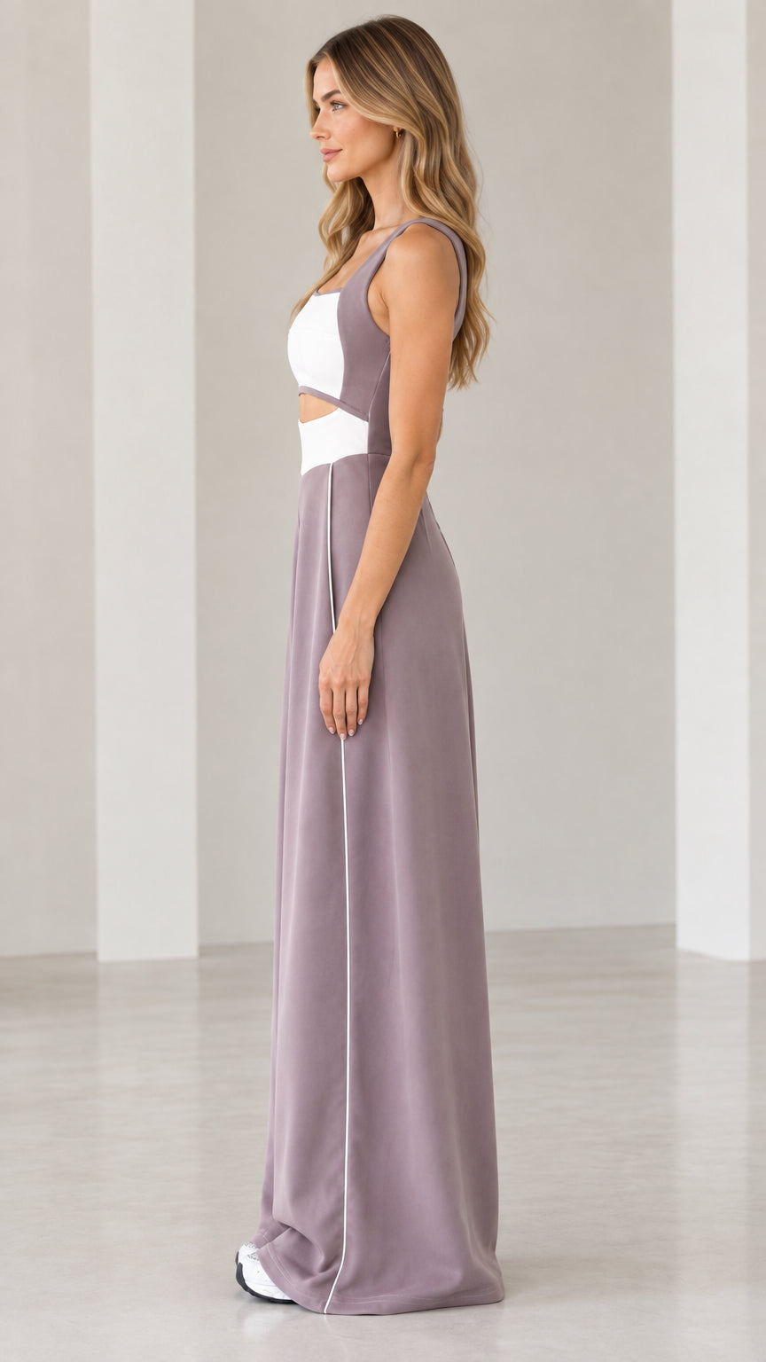Side profile view of woman wearing mauve colorblock cutout wide-leg jumpsuit