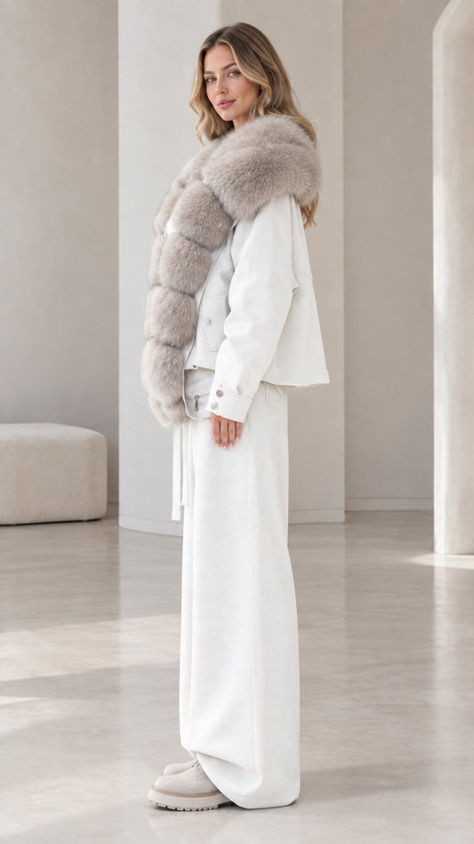 Side profile of model wearing white faux fur trim jacket and matching wide-leg trousers
