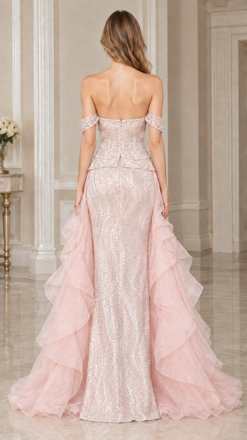Back view of model wearing Blush Pink sequin evening gown with dramatic cascading ruffle train