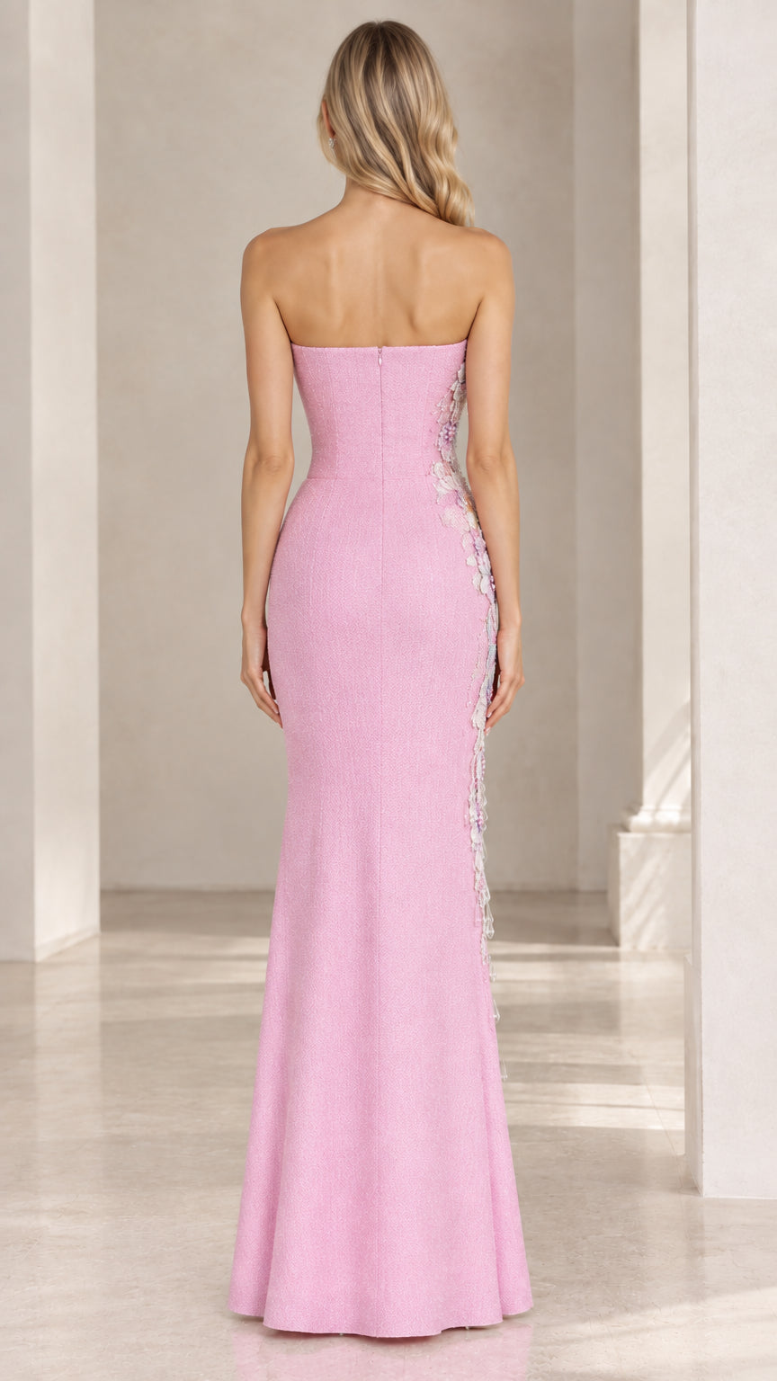 Back view of model wearing pink floor-length strapless evening dress