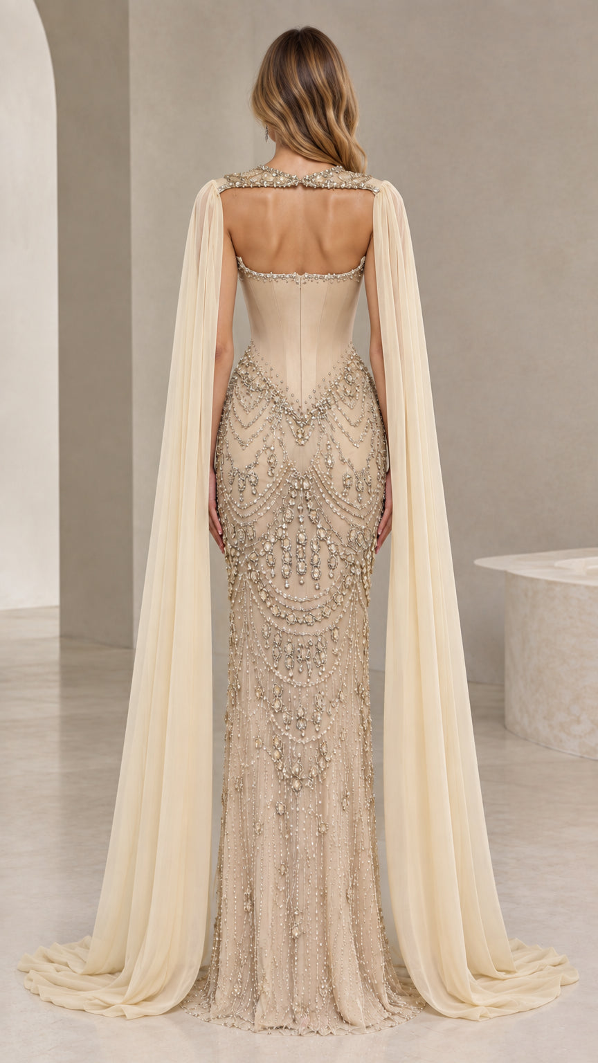 Champagne open back embellished evening gown with shoulder cape sleeves back view