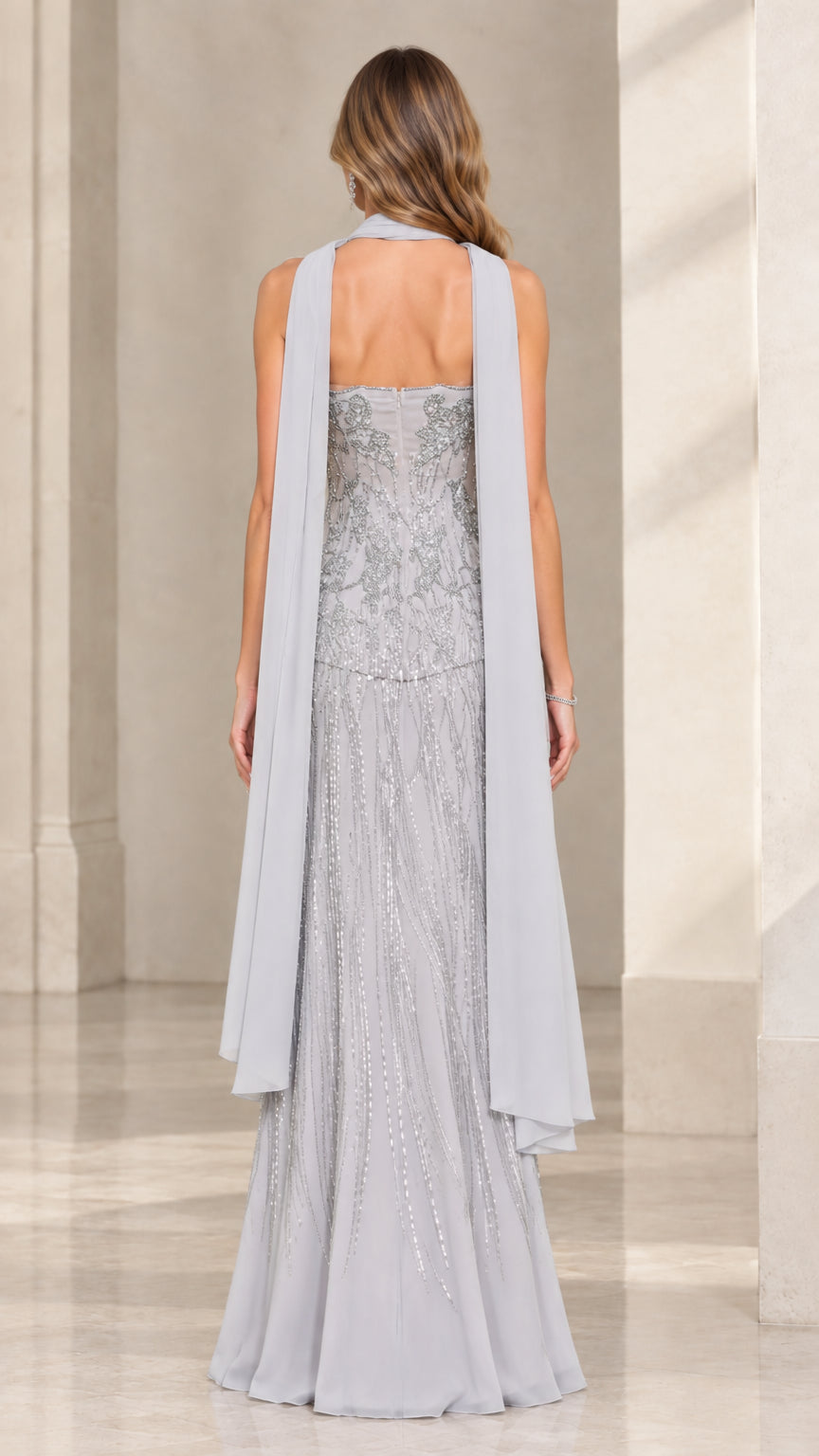 Back view of Silver Grey beaded strapless gown with sheer scarf flowing down the back