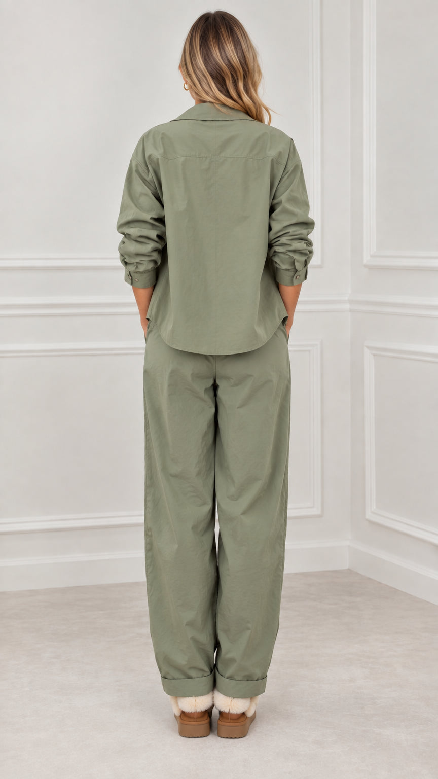 Back full view of woman wearing sage green relaxed utility tracksuit set