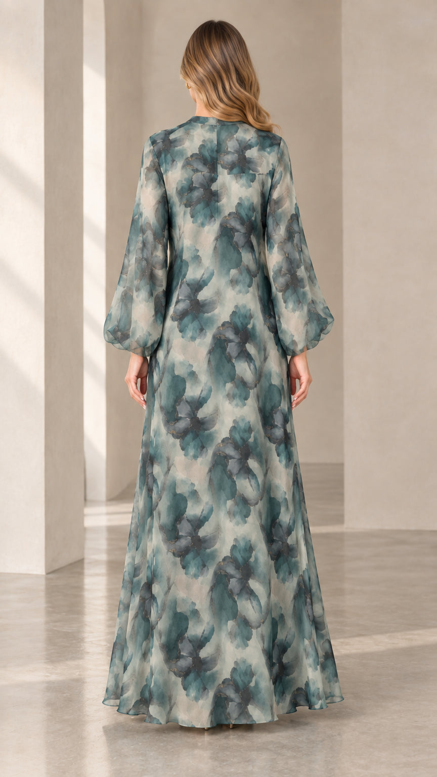 Back view of woman wearing flowy sage green chiffon maxi dress