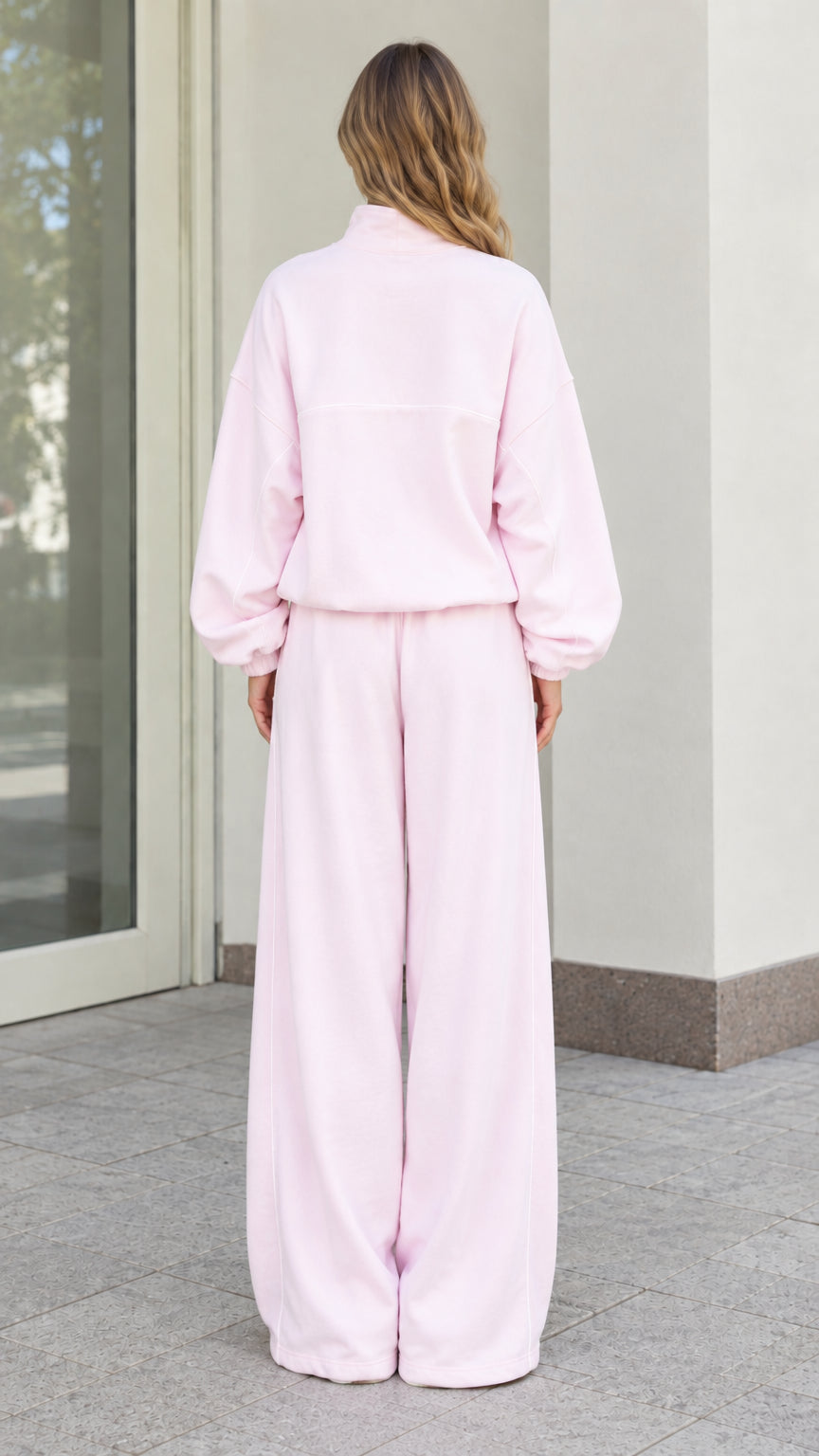 Back view of woman wearing Light Pink matching fleece top and wide-leg pants