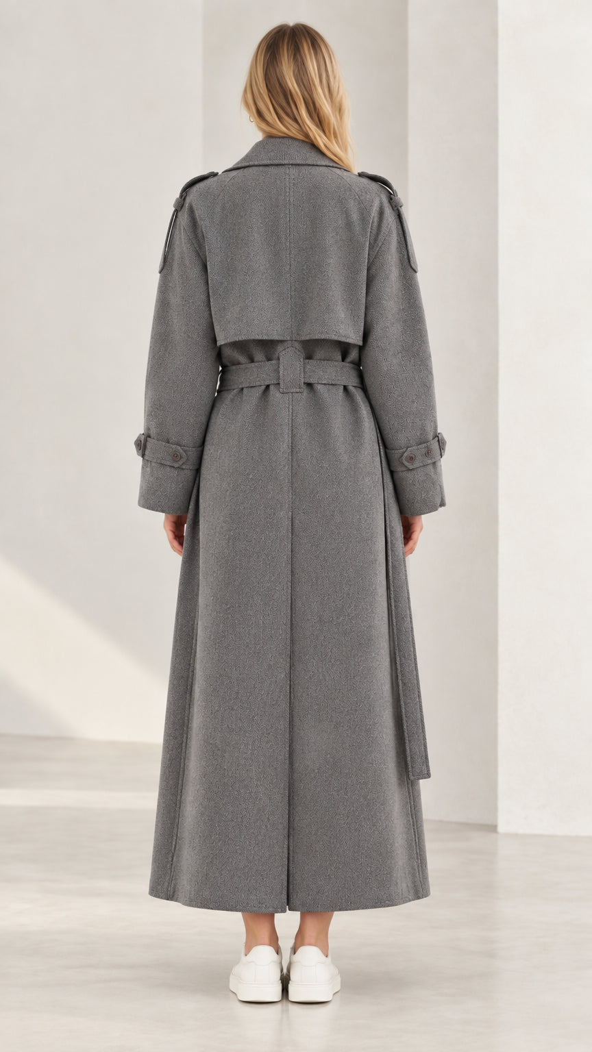Back view of grey maxi trench coat showing storm flap and back slit