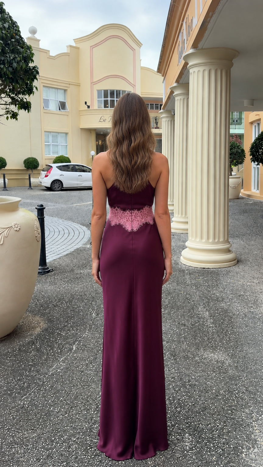 Back view of model wearing burgundy halter satin maxi dress