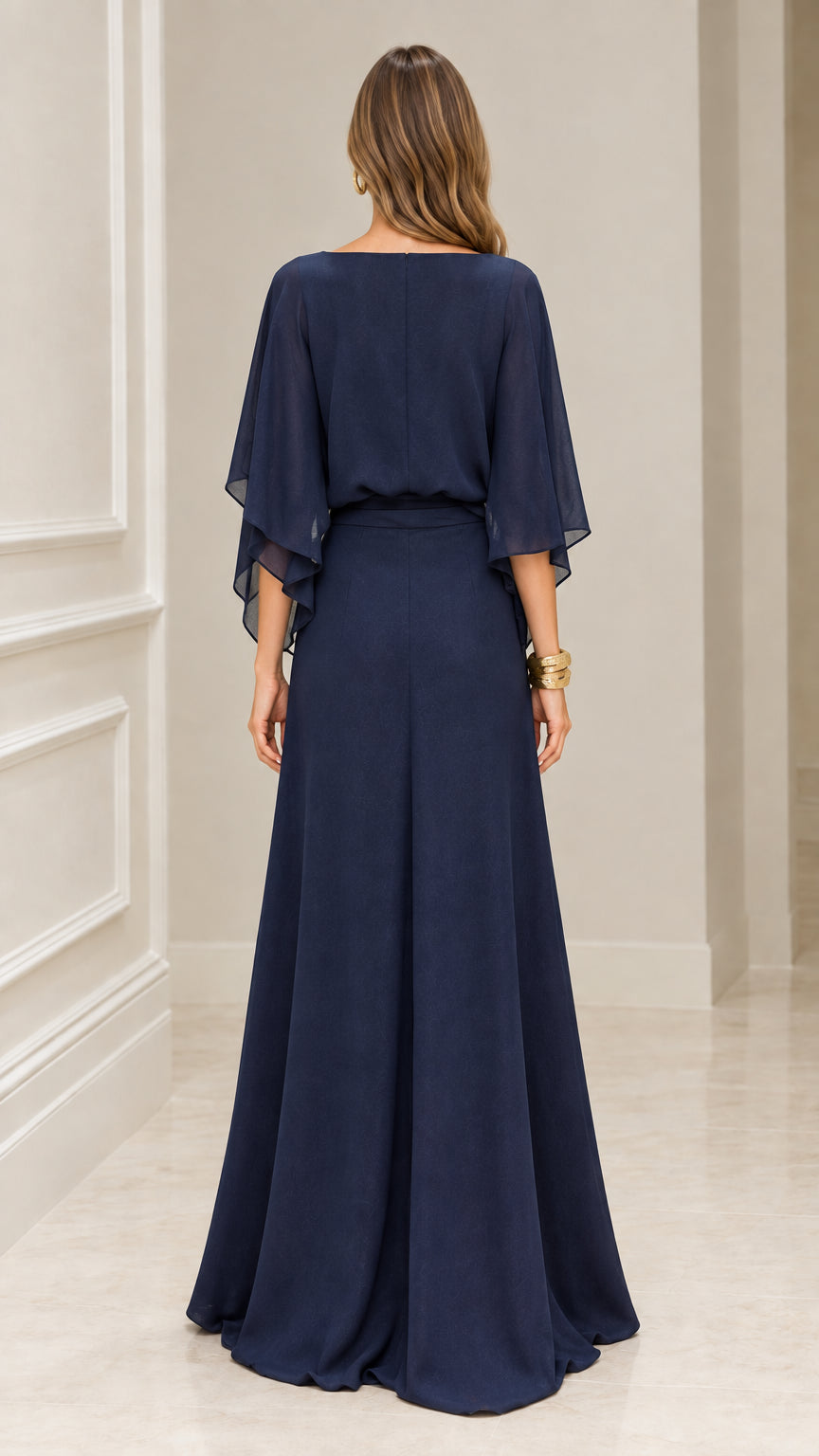Back view of model wearing Navy Blue boat neck maxi dress with cape sleeves