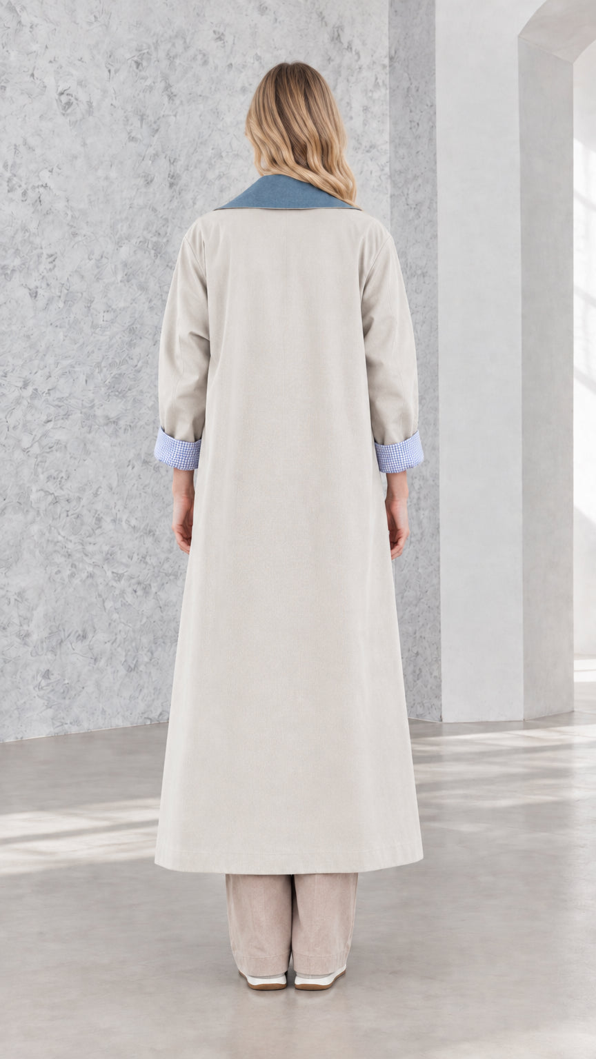 Back view of model showcasing maxi length and clean drape of light grey coat