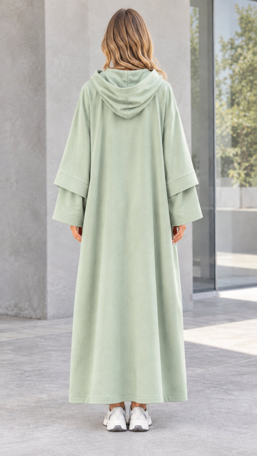 Back view of woman wearing sage green hooded maxi dress showing hood detail