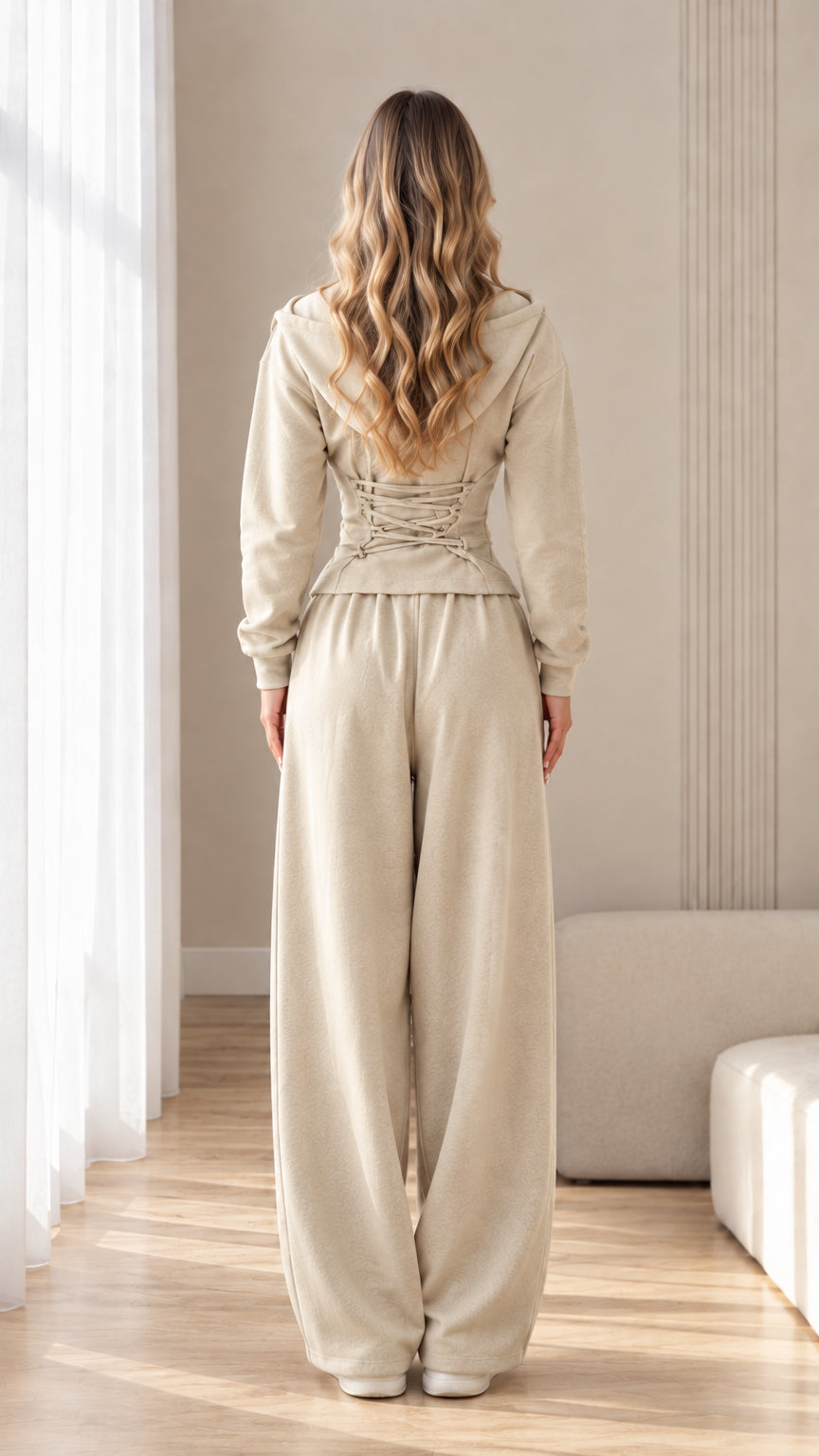 Back view of beige zip hoodie highlighting the lace-up corset waist detail
