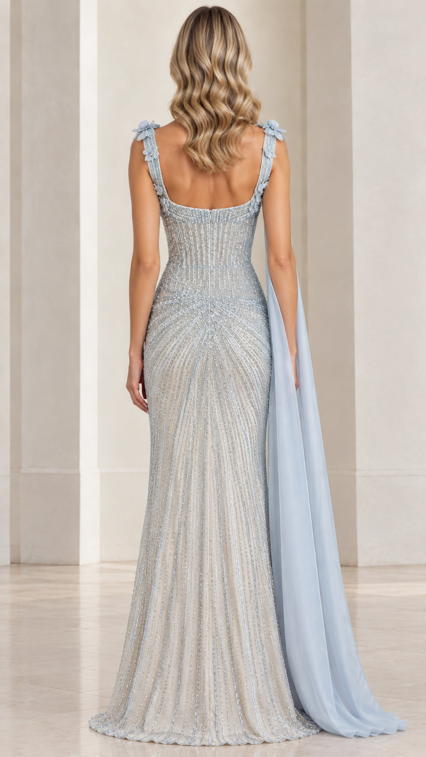 Back view of ice blue beaded gown highlighting low scoop back and floor-length drape