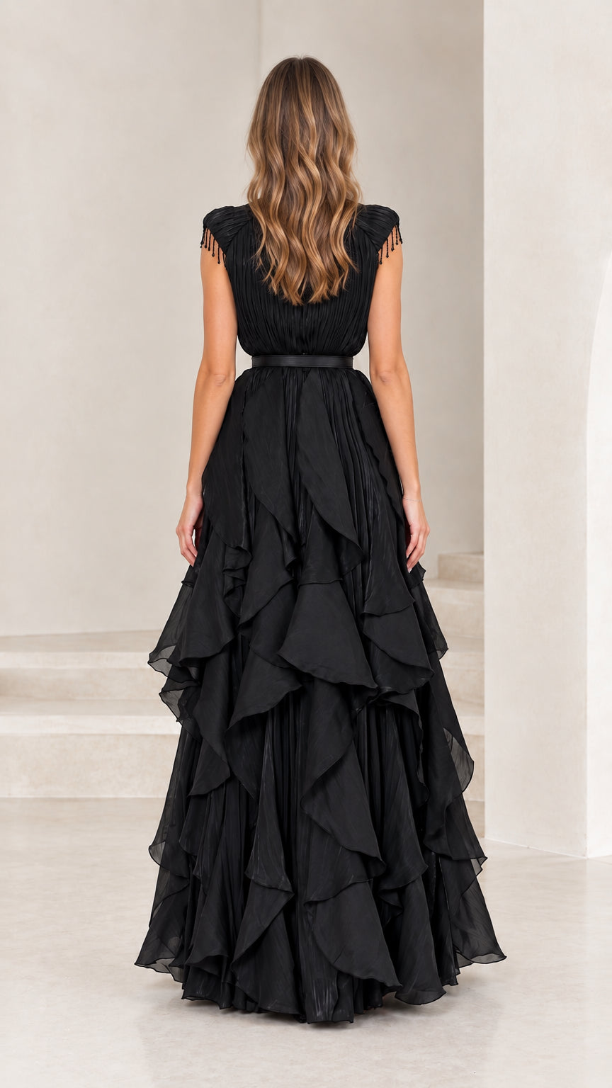 Back view of black high neck pleated tiered formal gown