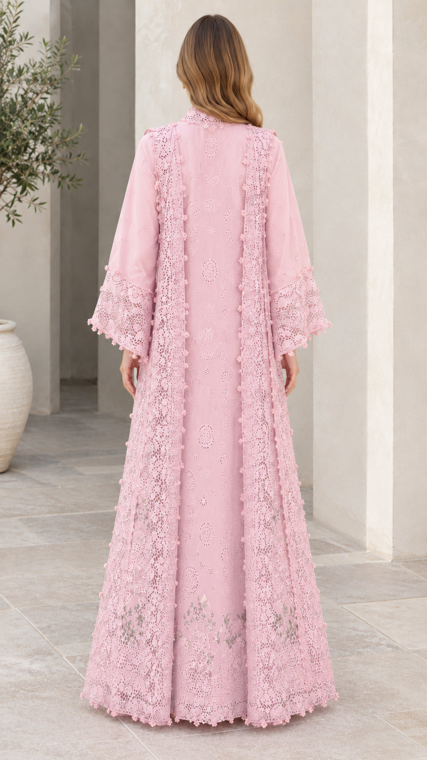 Back view of blush pink lace maxi dress featuring flared bell sleeves and flowing skirt
