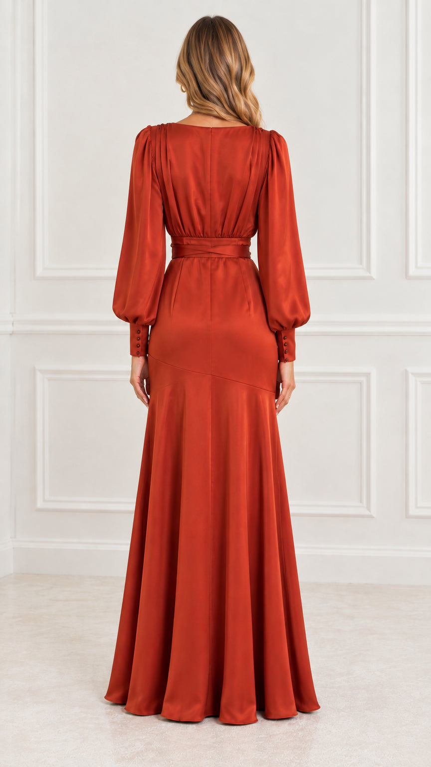 Back view of model in rust orange satin long sleeve maxi gown