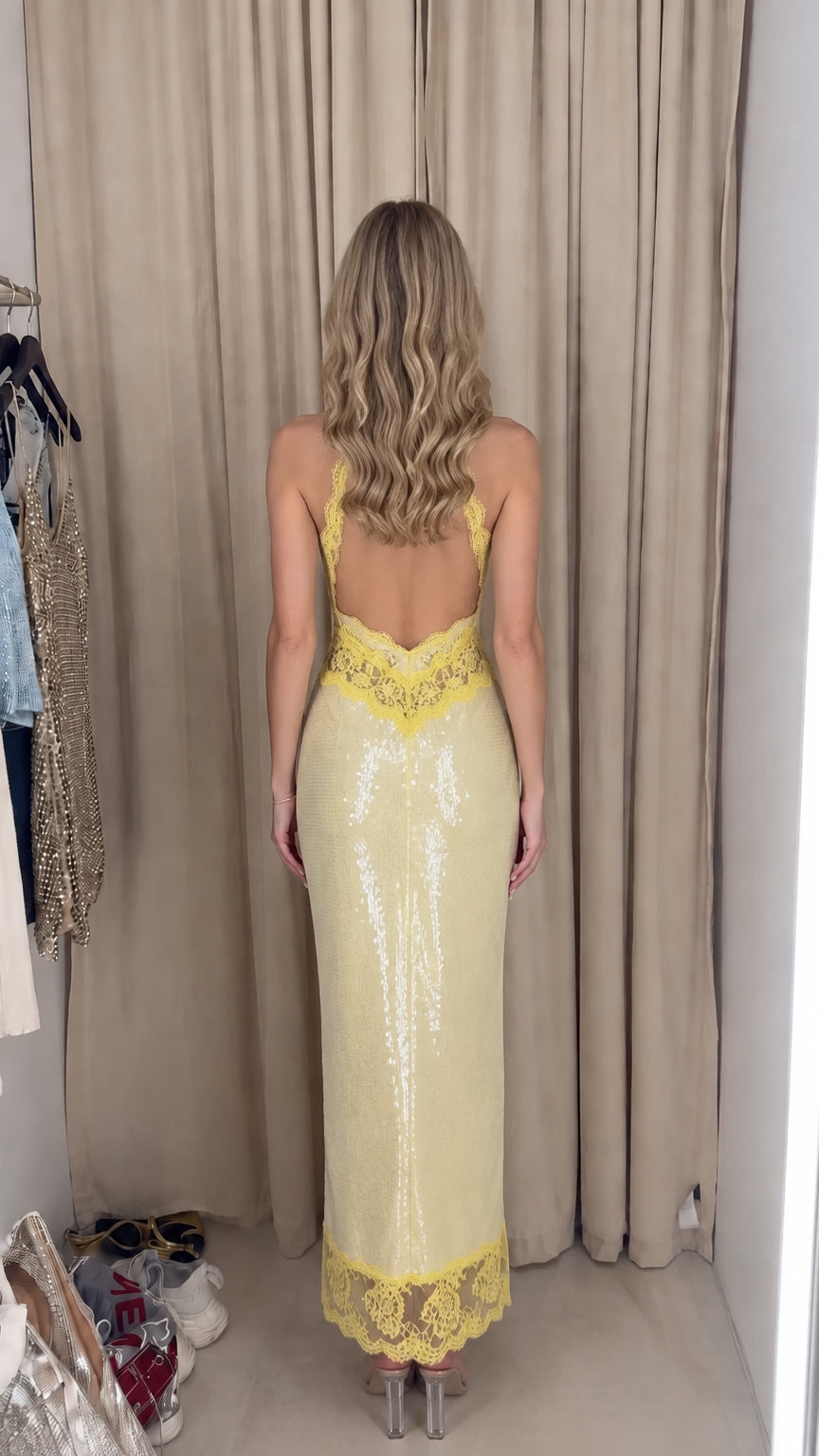 Back view of model showing low open back lace detail on Pale Yellow sequin maxi dress